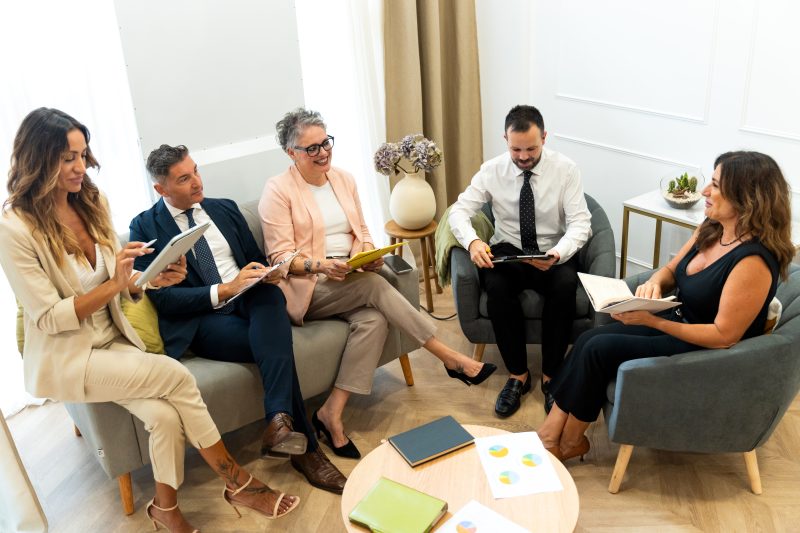 Business people having meeting using digital tablet and notebook in coworking space